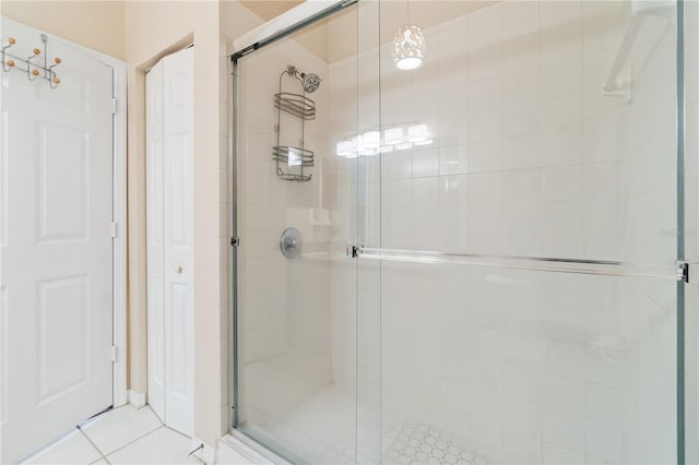 bathroom with tile patterned floors and walk in shower