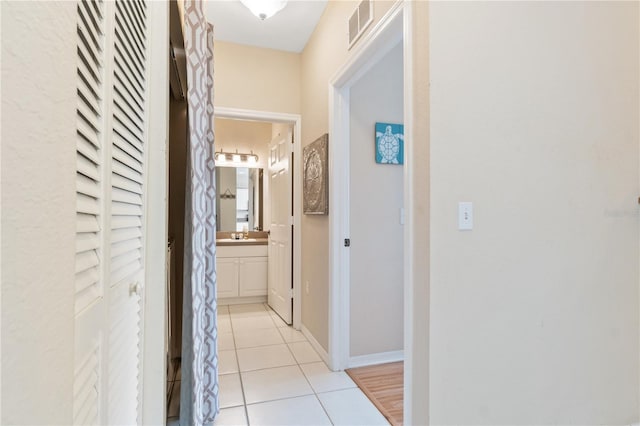 hallway featuring light tile patterned flooring