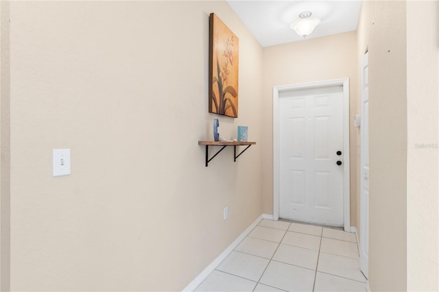 doorway to outside with light tile patterned flooring