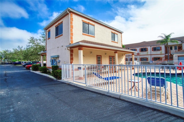 view of front of property with a community pool