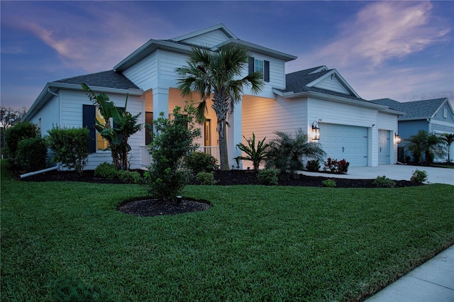 view of front facade featuring a yard and a garage