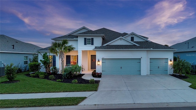 view of front facade with a yard and a garage