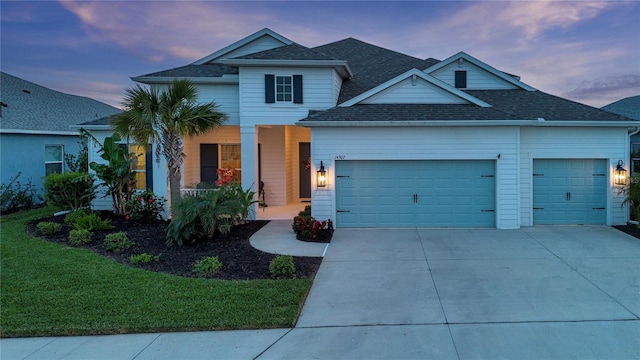 view of front of property featuring a yard and a garage