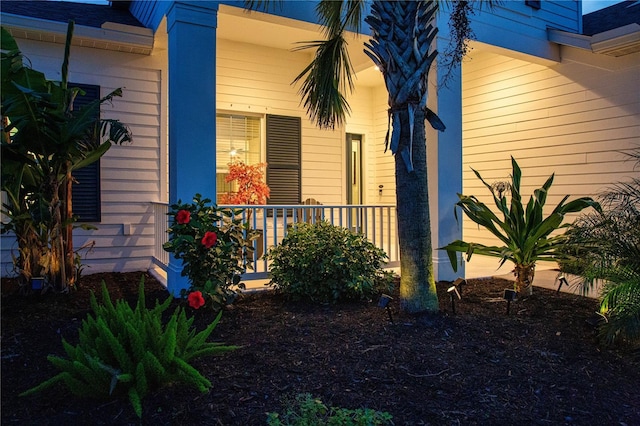 view of exterior entry featuring covered porch