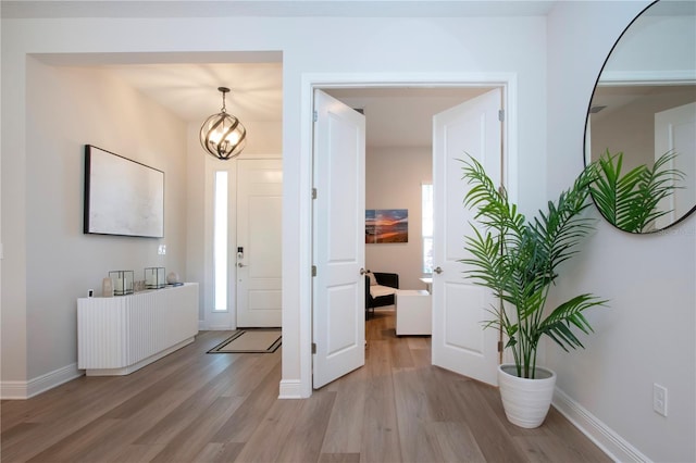 foyer featuring light hardwood / wood-style flooring and a chandelier