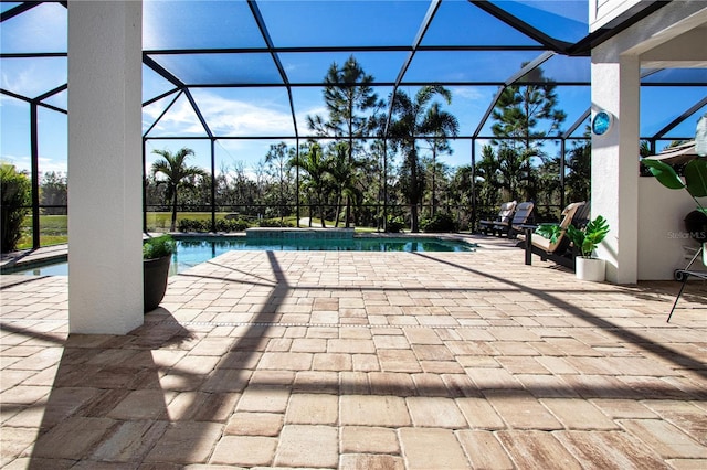 view of swimming pool featuring a lanai and a patio