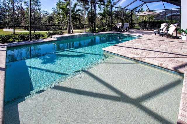 view of pool with a lanai and a patio