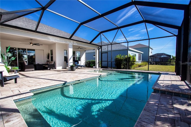 view of swimming pool with a lanai, ceiling fan, a patio area, and an outdoor living space