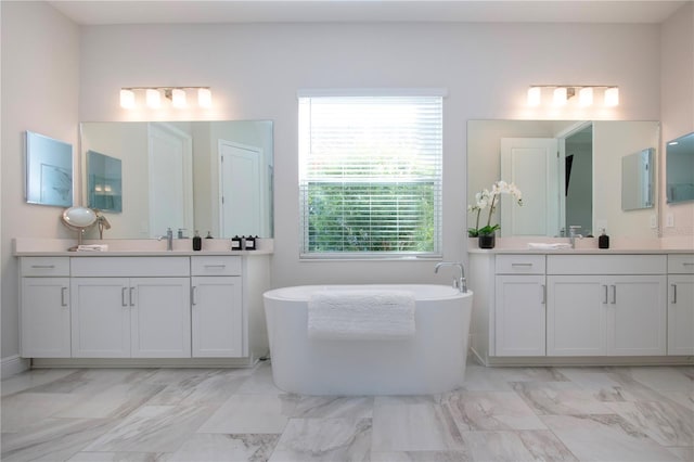 bathroom with vanity and a bath