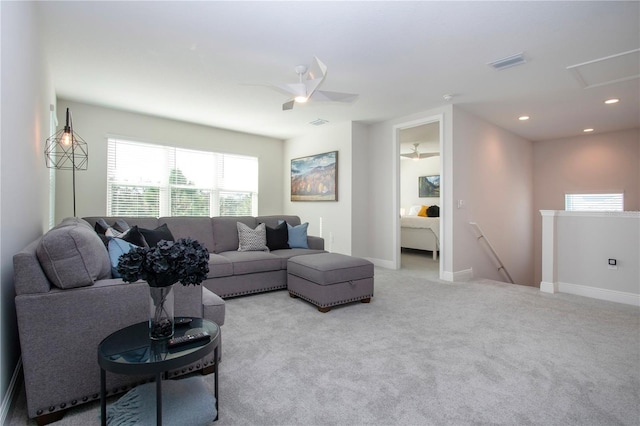 carpeted living room with ceiling fan