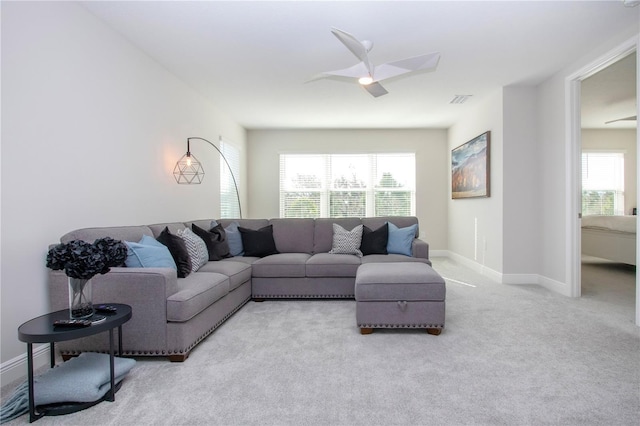 carpeted living room featuring ceiling fan