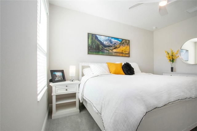 bedroom featuring light colored carpet and ceiling fan