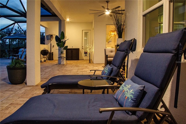 view of patio / terrace with ceiling fan and a lanai