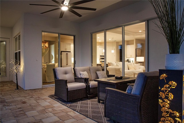 view of patio with an outdoor living space and ceiling fan