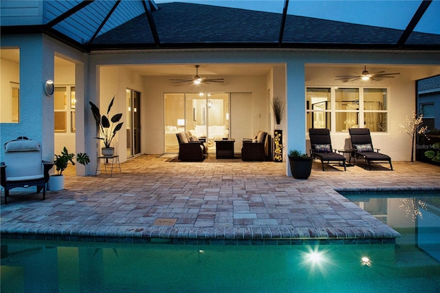 rear view of property with ceiling fan, a patio area, a lanai, and an outdoor hangout area