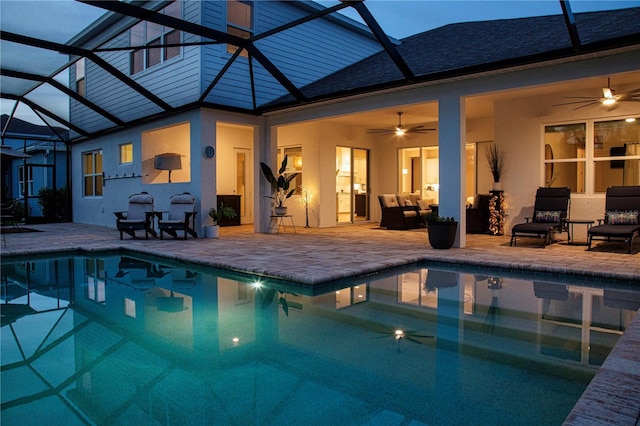 view of swimming pool featuring a patio area, ceiling fan, and a lanai