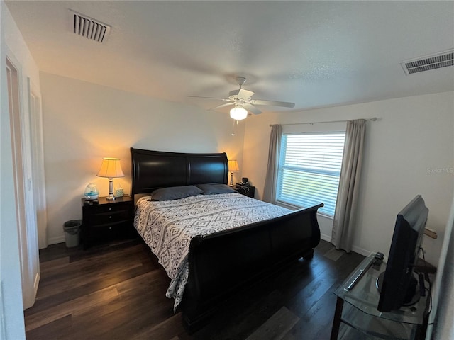 bedroom with ceiling fan and dark hardwood / wood-style flooring