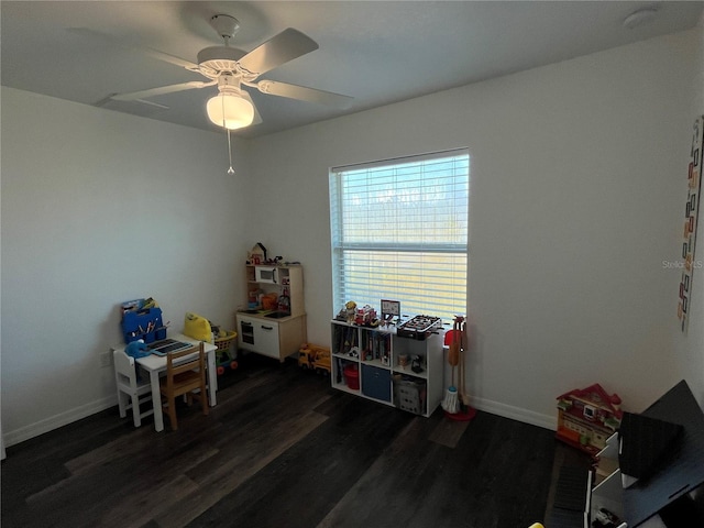 miscellaneous room featuring ceiling fan and dark hardwood / wood-style flooring