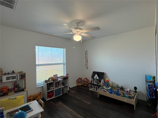 recreation room featuring dark hardwood / wood-style floors, ceiling fan, and plenty of natural light