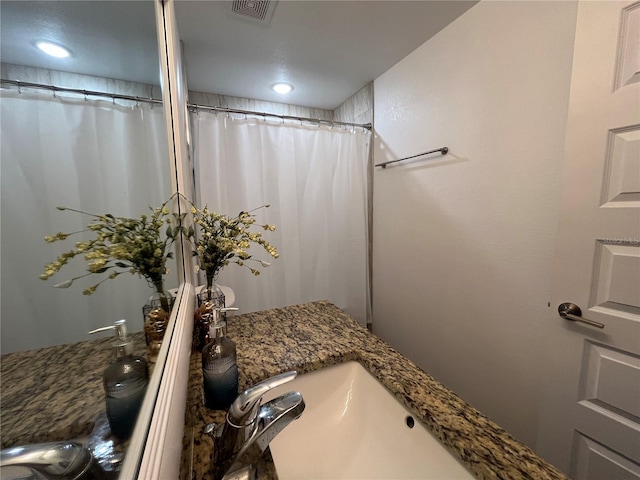 bathroom with vanity and walk in shower