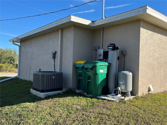 view of home's exterior with a yard and cooling unit