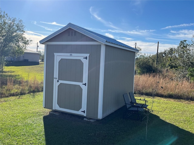 view of outdoor structure with a lawn