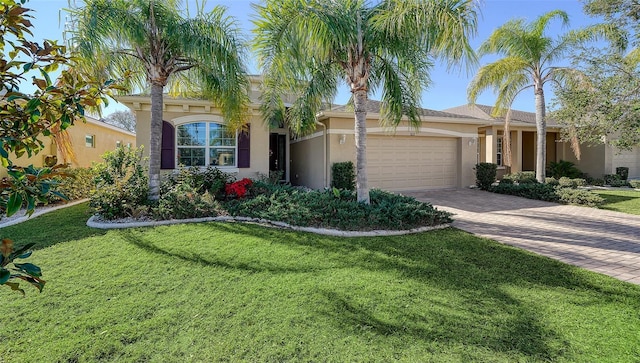 view of front of property featuring a garage and a front lawn