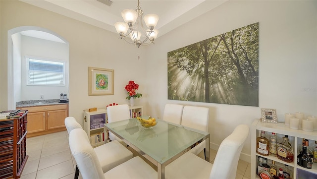 dining space featuring light tile patterned floors and a chandelier