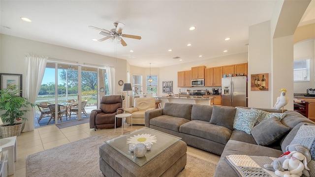 tiled living room with ceiling fan