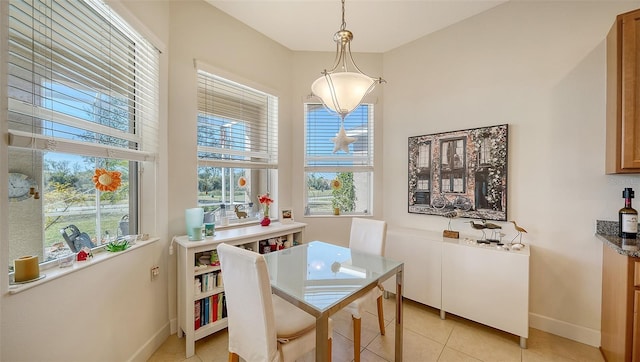 dining area featuring a wealth of natural light and light tile patterned flooring