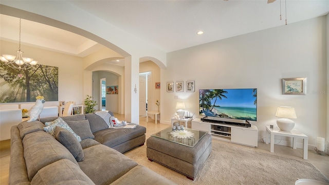 living room with light tile patterned flooring and an inviting chandelier