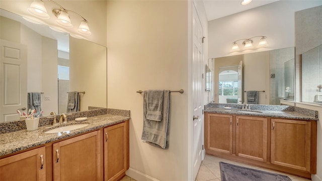 bathroom with tile patterned flooring, vanity, and an enclosed shower