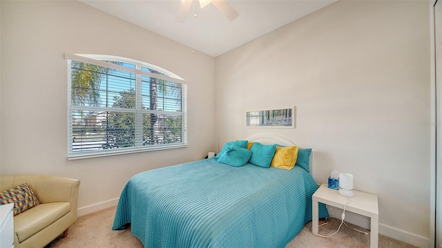 carpeted bedroom featuring multiple windows and ceiling fan