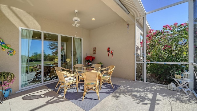 view of patio featuring glass enclosure and ceiling fan