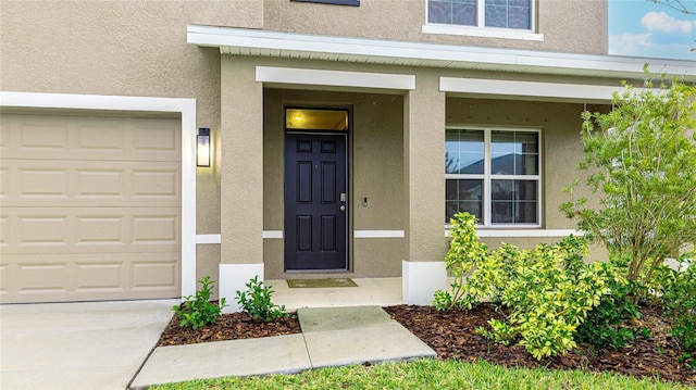 property entrance featuring covered porch and a garage