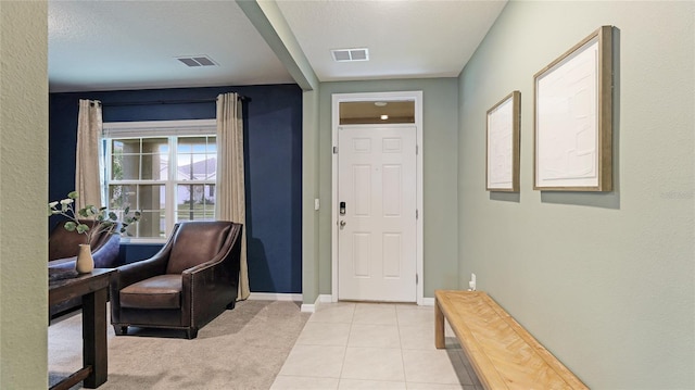 tiled foyer with a textured ceiling