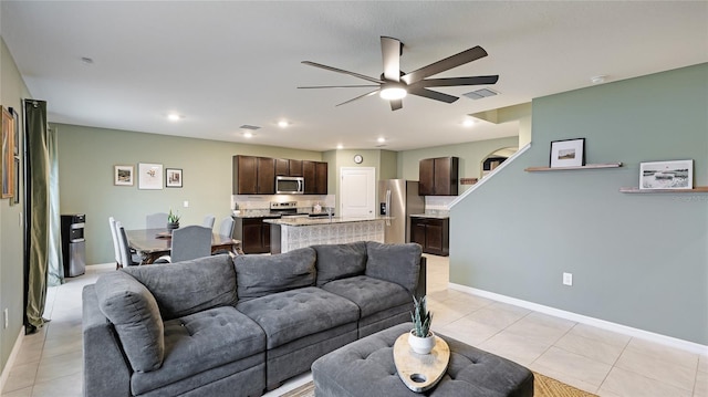 tiled living room featuring ceiling fan