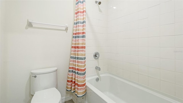 bathroom with shower / bath combo and toilet