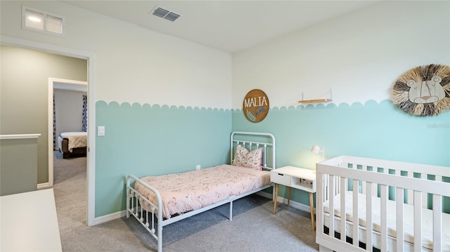 bedroom featuring carpet and a nursery area