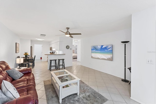 tiled living room with ceiling fan