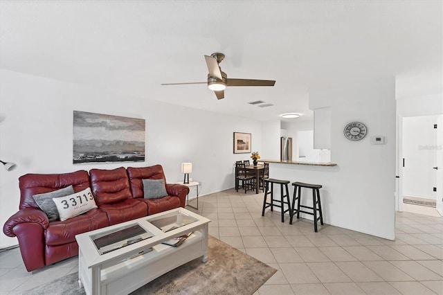 tiled living room featuring ceiling fan