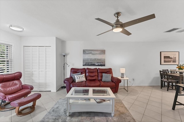 tiled living room featuring ceiling fan