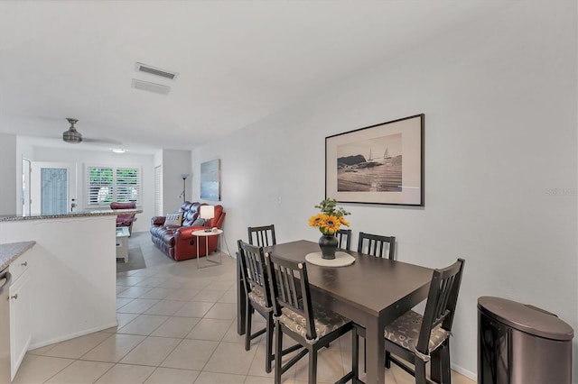 tiled dining room with ceiling fan