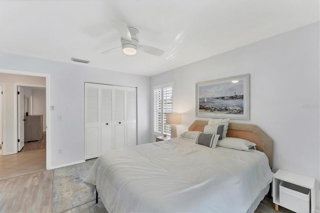 bedroom featuring hardwood / wood-style floors, a closet, and ceiling fan