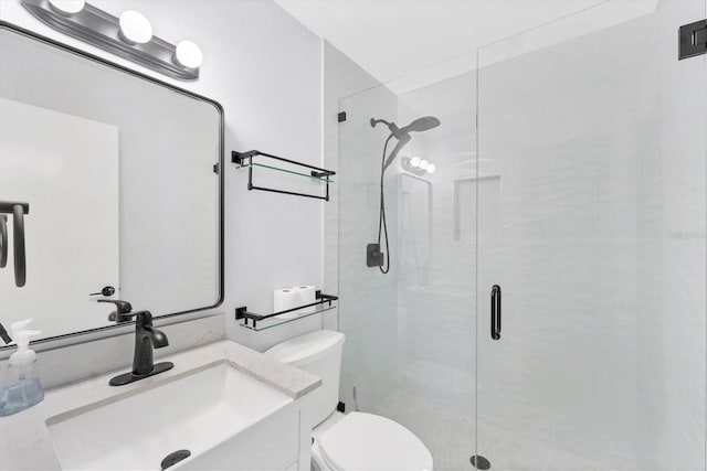 bathroom with an enclosed shower, vanity, and toilet