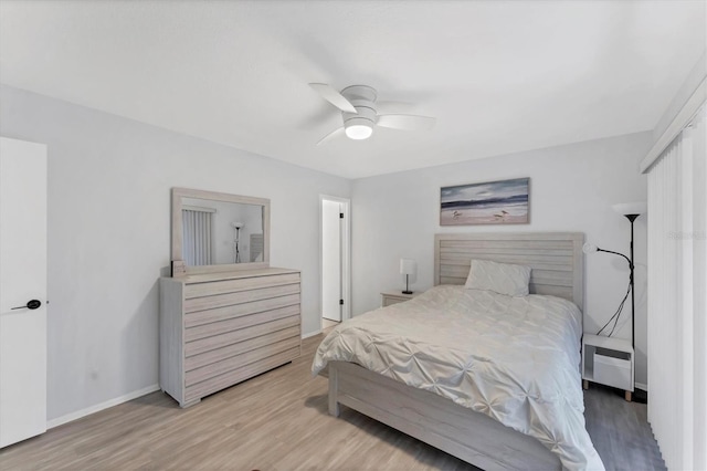 bedroom with ceiling fan and hardwood / wood-style flooring