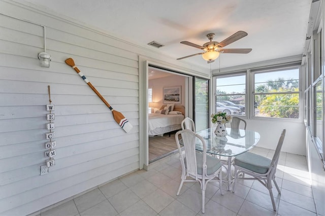 sunroom featuring ceiling fan