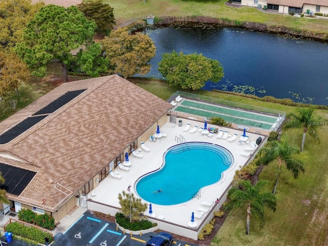 view of swimming pool featuring a water view