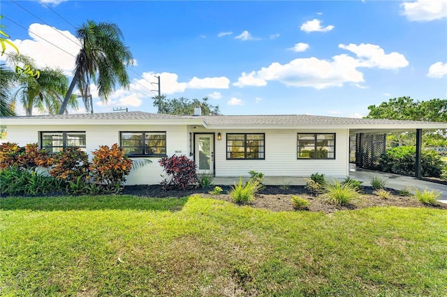 ranch-style house featuring a carport and a front yard