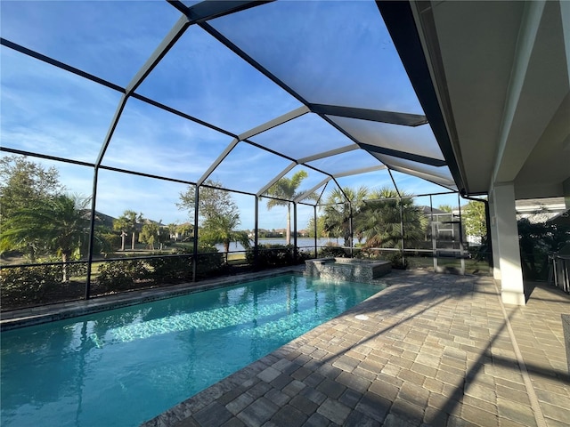 view of swimming pool with a patio area and a lanai